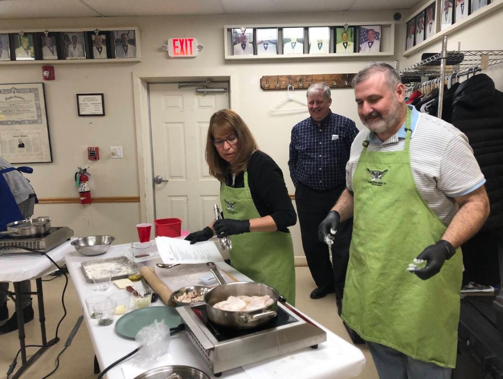 Members cooking together at the lodge Italian cooking event