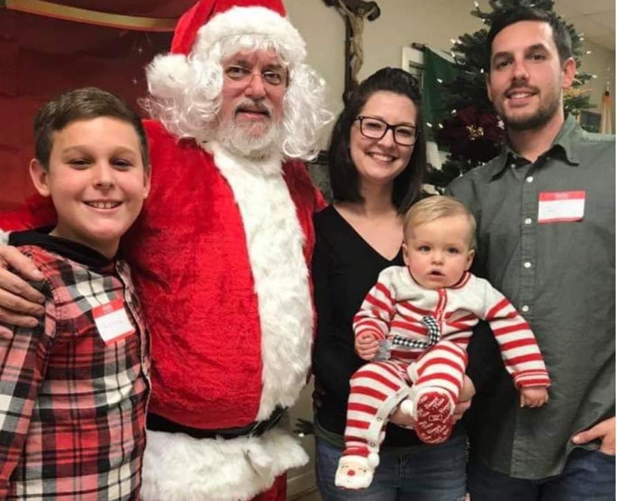 Family with Santa at the holiday party