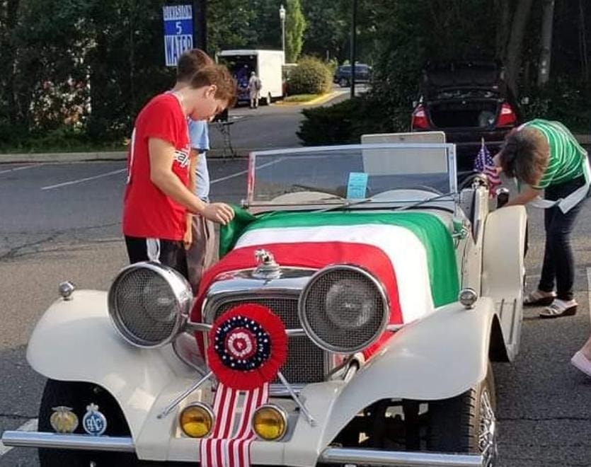 Vintage car decorated with Italian flag at the parade