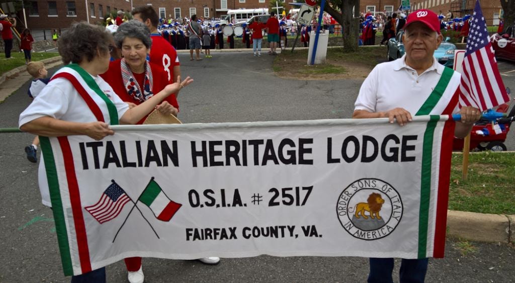 Members holding the Italian Heritage Lodge banner
